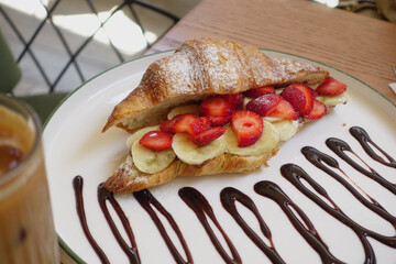 A Delicious Croissant Filled Generously with Fresh Strawberries and Bananas