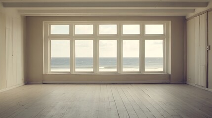 An empty beach house apartment with wooden floors and a sea view from windows, providing a serene and spacious setting with ample copy space for various creative uses