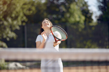 Caucasian female tennis player playing on the court outdoors