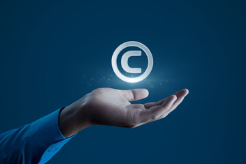 Human Hand Holding Copyright C Symbol. Intellectual Property Protection Concept