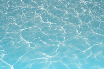 Clear blue water background, reflected ripple across the pool, top view of summer surface of swimming pool with sunlight, design for cosmetic product ,skincare wallpaper