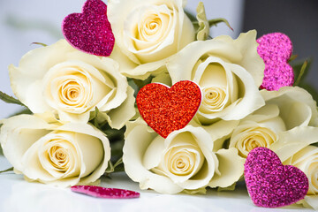 A glittery red heart lies atop elegant white roses, symbolizing love and purity. A perfect representation of romance, passion, and beauty for Valentine's Day