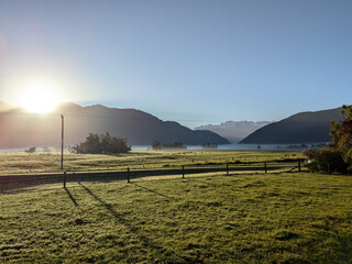 Panorama of a dairy farm with the peaks of the Southern Alps near Franz Joseph New Zealand in Whataroa