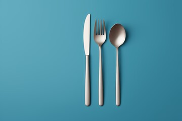 there are two forks and a spoon on a blue background