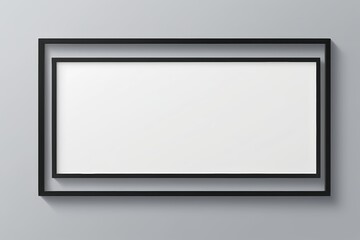 black frame with white blank paper hanging on the wall