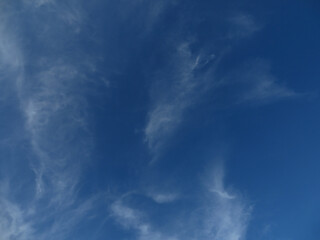 Dreamy Whispers: Ethereal White Wisps Against Deep Blue Skies in Dong Hoi, Quang Binh, Vietnam