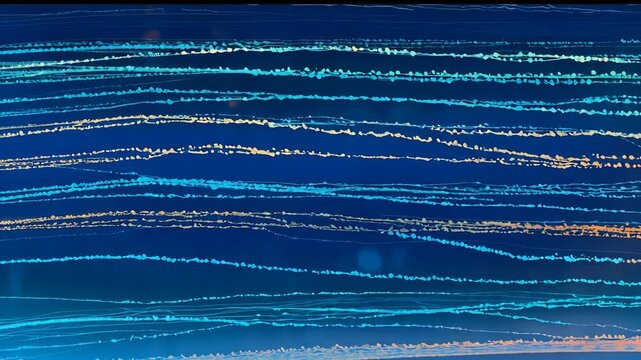 Video footage of parallel, wavy lines in various shades of blue and white against a dark blue background, resembling ocean waves currents