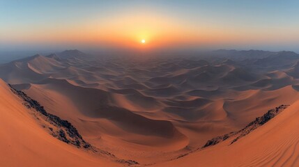 Fototapeta premium Panoramic sunset view over vast, undulating sand dunes in a desert landscape.