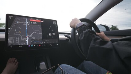 Woman use GPS navigater screen in EV car travel trip transport technology