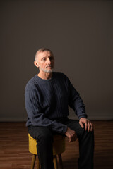 Authentic studio portrait of a handsome older man, selective focus