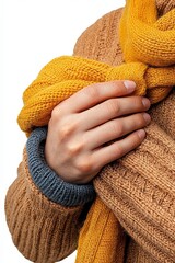 Hands wrapping a warm scarf around themselves, isolated on white