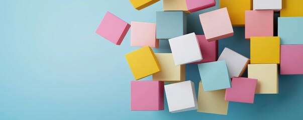 Colorful blocks scattered on a light blue surface create a playful and vibrant composition, ideal for children's activities and educational themes.