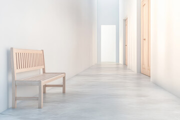 Simple wooden bench in a minimalistic hallway with closed doors and bright light