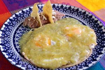 Fried eggs served with beans in a talavera dish