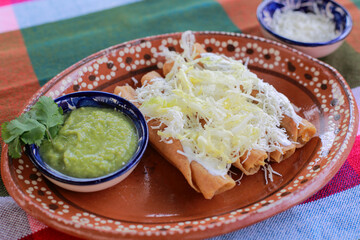 Tacos dorados served with guacamole