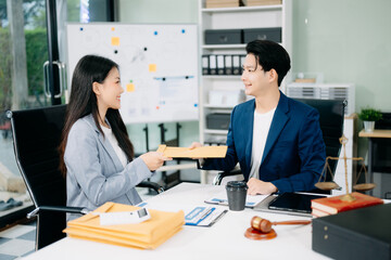 Asian business team and lawyers discussing contract papers sitting at the table. Concepts of law,