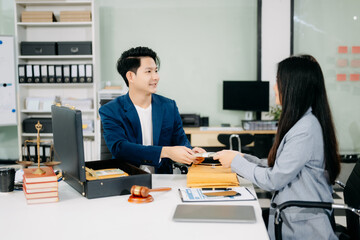 justice and law concept.passing bribe money in the envelop at lawyer office.