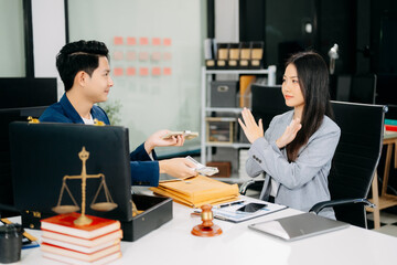 justice and law concept.passing bribe money in the envelop at lawyer office.