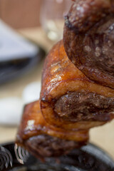 Close-up of grilled Picanha beef skewer with crispy fat and juicy steak.