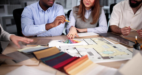Designer Group At Desk Discussing Custom House