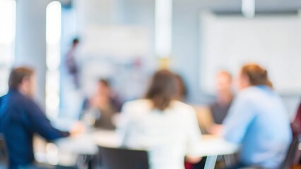A blurred image showcasing an informal team meeting or huddle.
