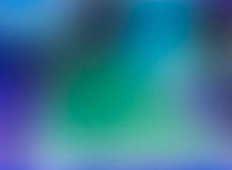 The image is a blurry, abstract photo with a gradient of blue and green colors. It has a dreamlike and ethereal quality.
