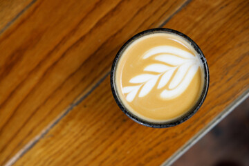 Cup of hot latte coffee by the street