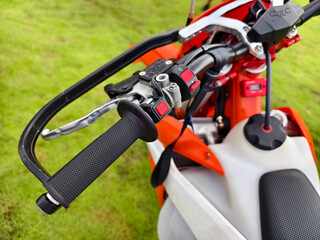 A detailed close up view focusing on the handlebars of a dirt bike