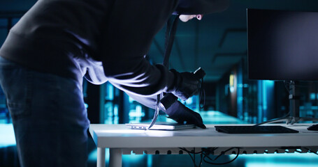 Thief Stealing Laptop Computer From Office