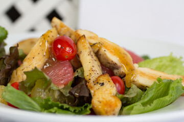 Close-up of grilled chicken salad with juicy cherry tomatoes and honey mustard dressing, vibrant healthy gourmet presentation.