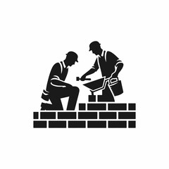 Silhouette image of two construction workers engaged in the process of building a brick wall.