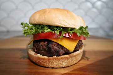 Homemade cheeseburger with lettuce and tomato