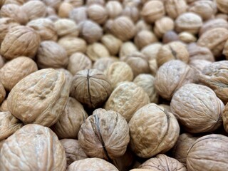 Closeup of brown, textured walnuts in shells