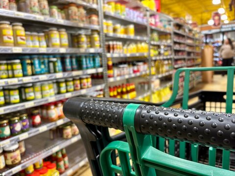 Closeup of black and green shopping cart in grocery store