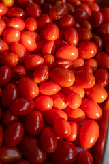 Close up organic red small tomatoes background
