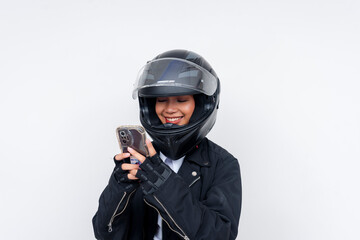 An enthusiastic young rookie Asian woman delivery rider checks her smartphone, likely for an order...