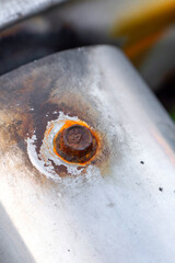 Close-up rusty bolt on metal surface