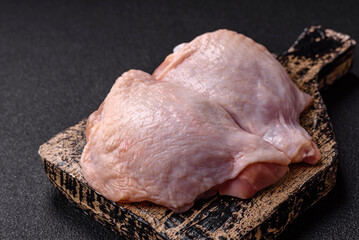 Fresh raw chicken thighs with salt and spices