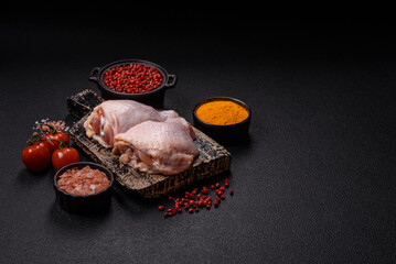 Fresh raw chicken thighs with salt and spices