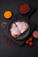 Fresh raw chicken thighs with salt and spices