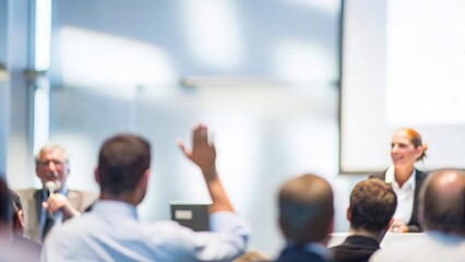 A blurry background of business professionals engaged in a lively debate during a conference.
