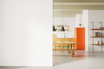 Blank white wall mockup and modern kitchen interior with orange fridge, wooden furniture, and minimal decor. 3D Rendering