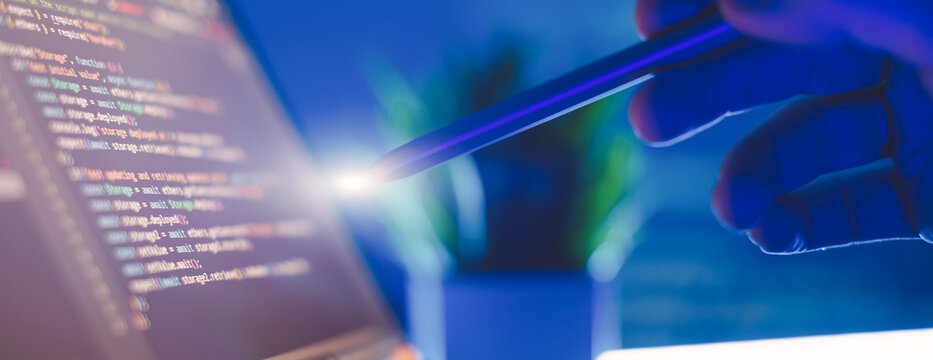 Work from home. Programmer coding code on notebook screen at home.