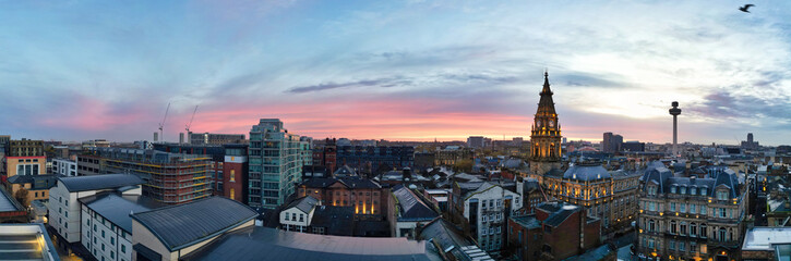 Fototapeta premium High Angle Ultra Wide High Resolution Panoramic View of Historical Liverpool City of England During Orange Sunrise Moring Time. Drone's Camera Footage on November 11th, 2024 from Medium High Altitude