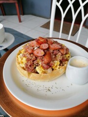 scrambled eggs and bacon on a waffle. Best Breakfast