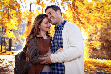 Fototapeta premium Beautiful couple in love on a walk in autumn forest