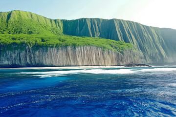 Majestic cliffs rise above crystal clear ocean waters in a tropical landscape during sunny daylight