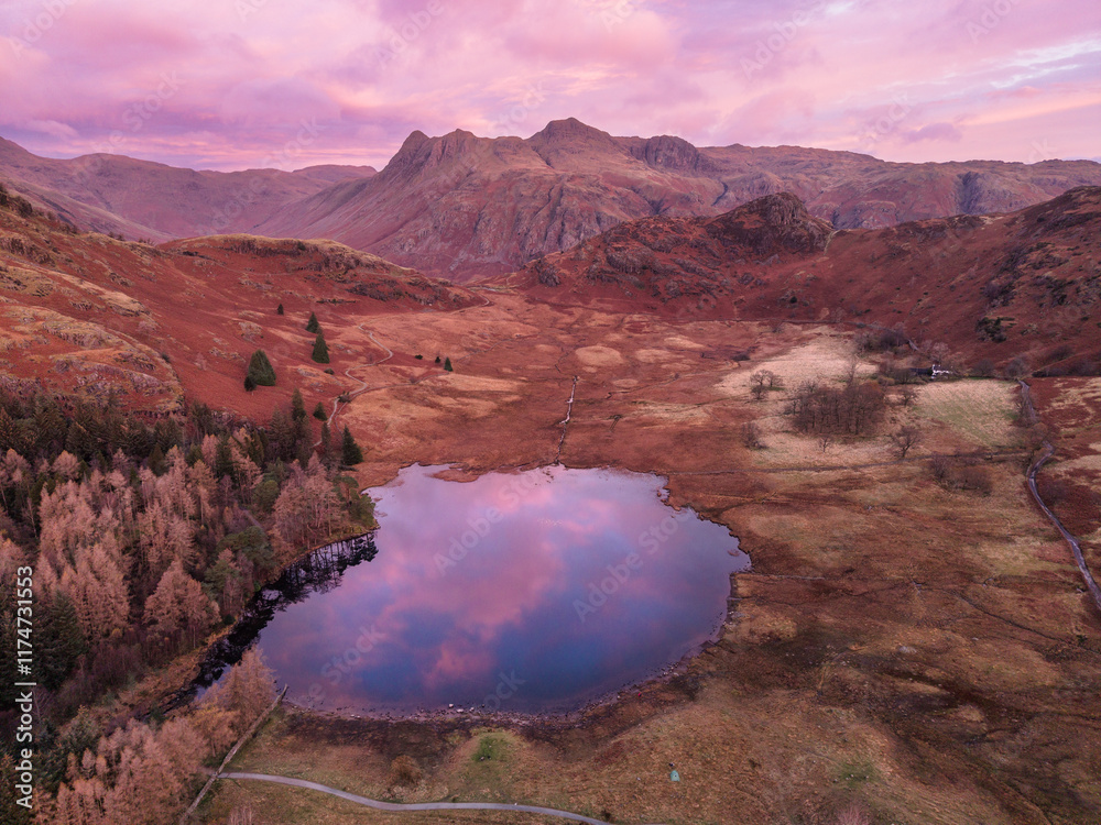 Poster Beautiful aerial drone landscape image of Blea Tarn and Langdale Valley in Lake District during vibrant Autumn sunrise