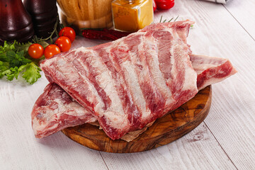 Raw pork ribs over board