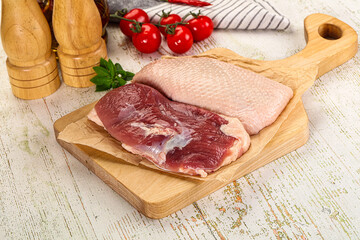 Raw duck breast over board